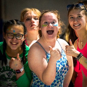 Swimmers give the camera a "thumbs up"